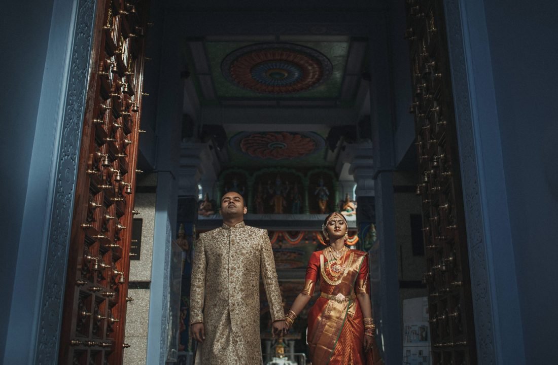 Kay and Srijith in traditional Indian wedding attire at a Singapore temple.