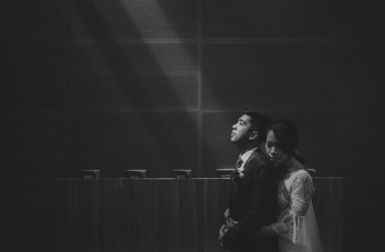 Cerlyn and Justin embrace at St Mary of the Angels Church wedding in Singapore.