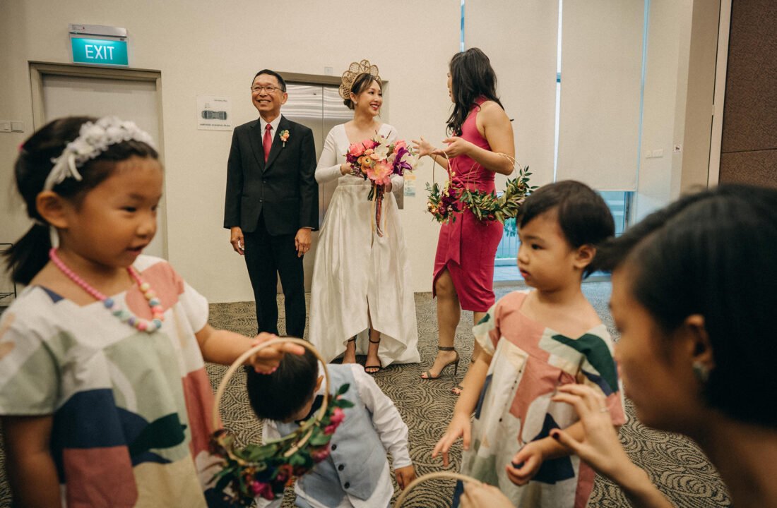 bride standing ready with flower boys and girls in the foreground at holy grace presbyterian church wedding in singapore