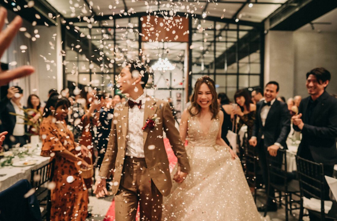 A tender moment between newlyweds marching in at The Ahava warehouse wedding Singapore