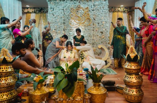 Family members gathered closely during ceremony at Sri Ruthra Temple by singapore wedding photographer