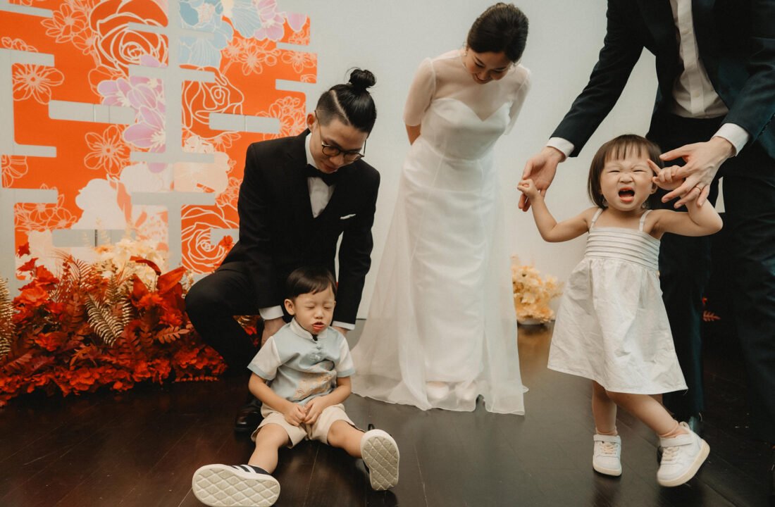Wedding party with bride, groom, and children at Wesley Methodist Church Singapore.