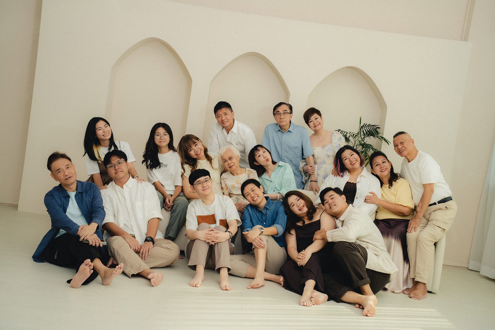 family enjoying a candid family photoshoot at Studio 19 Singapore with laughter and grandma present