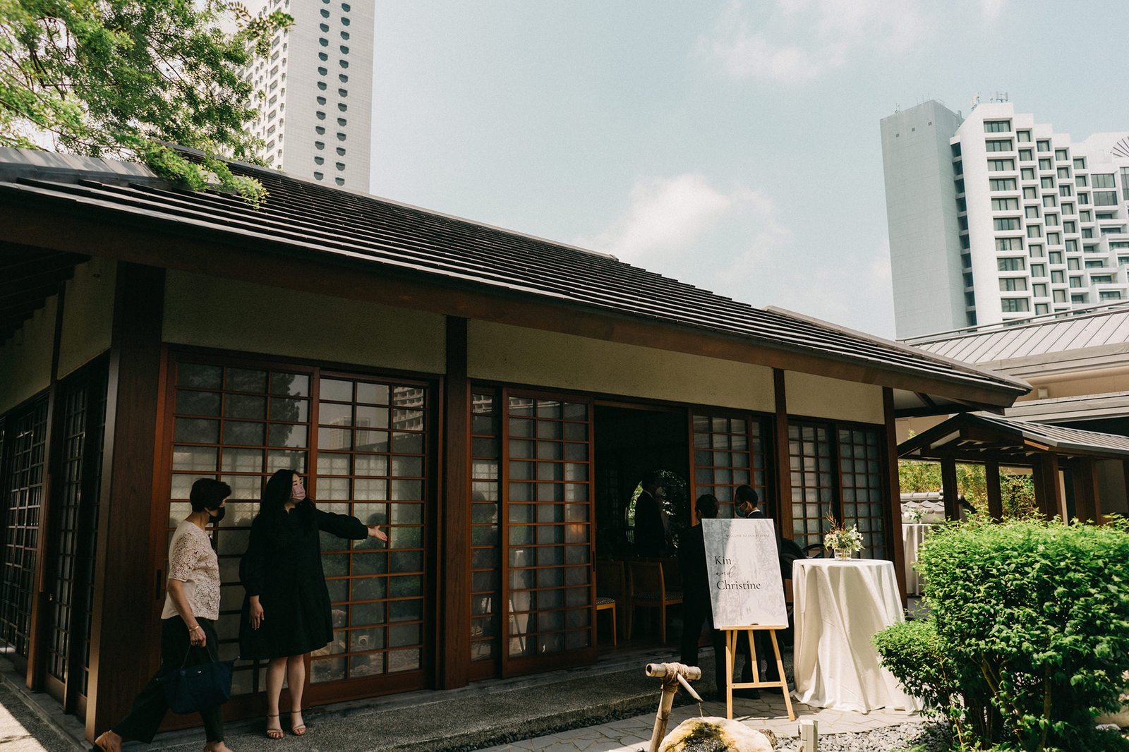 Kin + Christine's wedding at the Keyaki Garden Pavilion Singapore, featuring a Japanese-style building with sliding doors, guests, and a welcome sign.