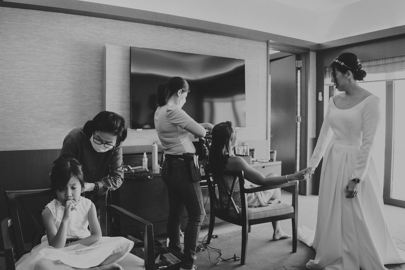 Bride in elegant white gown getting ready with bridesmaids and flower girl at a Keyaki Garden Pavilion wedding in Singapore.