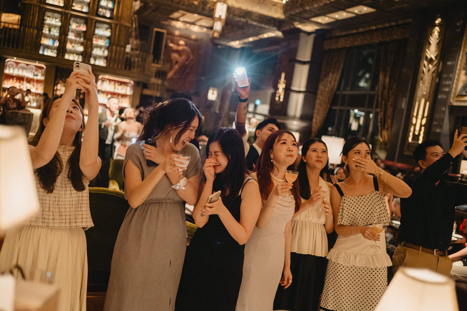Guests at Atlas Bar Singapore wedding toast during reception