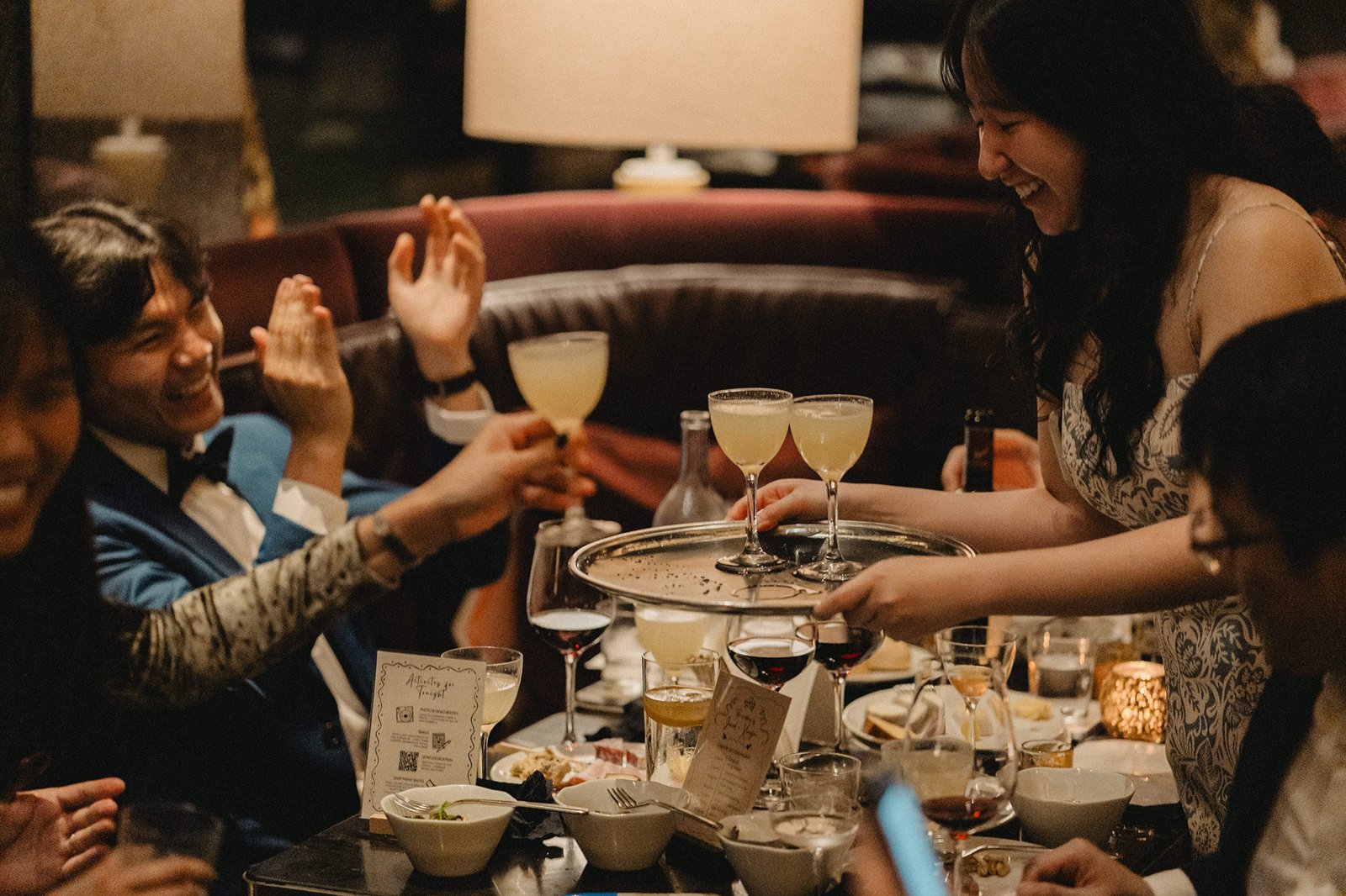 Jared and Xinyu's wedding guests toast drinks at Atlas Bar Singapore.