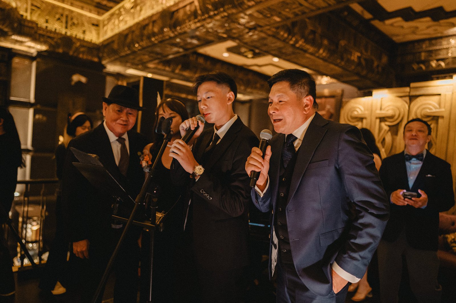 Jared and Xinyu's wedding at Atlas Bar Singapore, with guests singing.