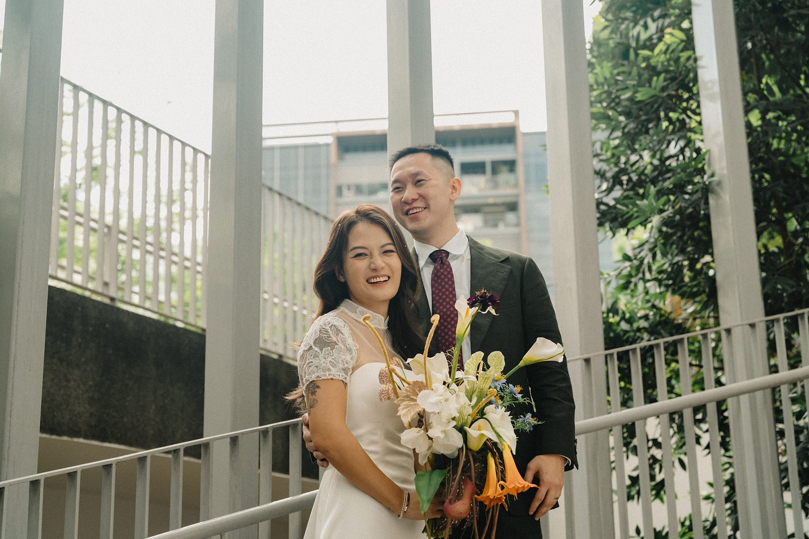 Jared and Xinyu smile at Atlas Bar Singapore wedding.