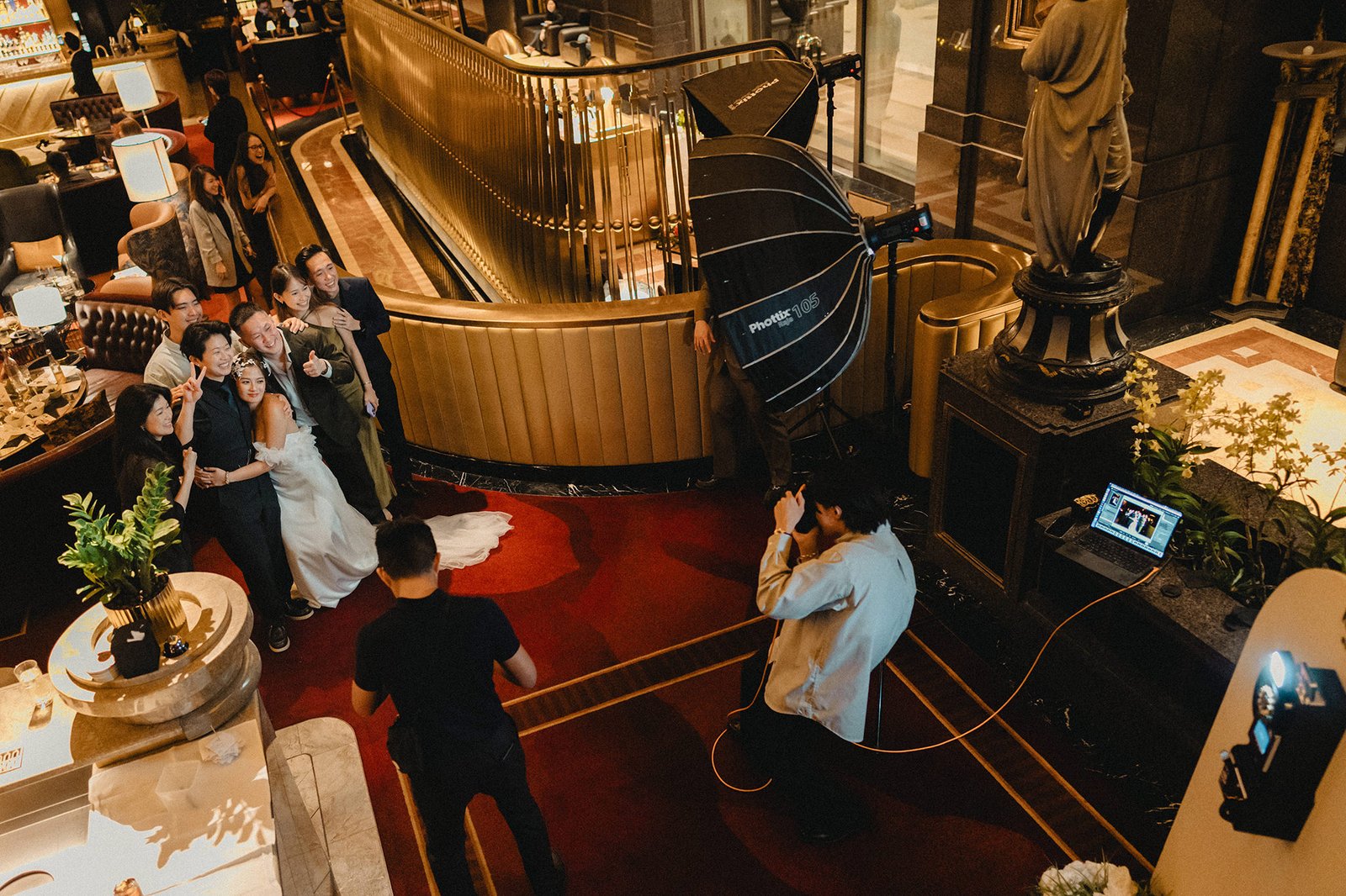 Jared and Xinyu wedding portrait at Atlas Bar Singapore, guests watch.