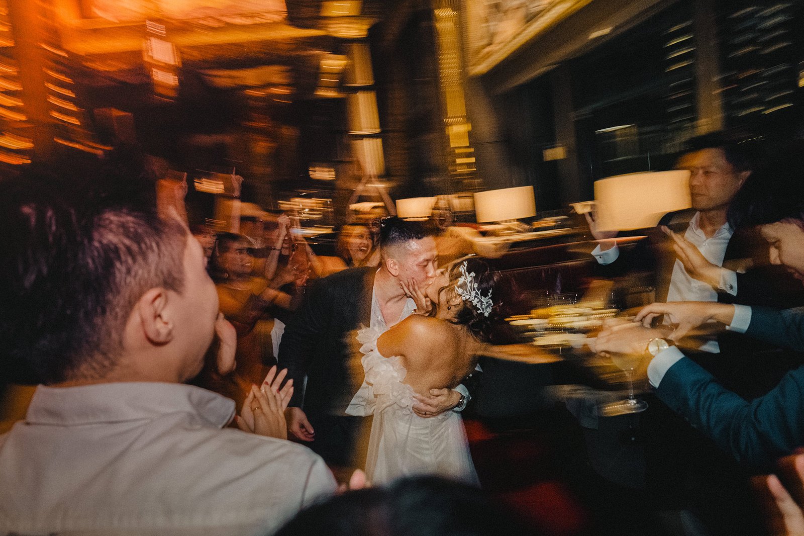 Jared and Xinyu kiss at their Atlas Bar Singapore wedding reception.