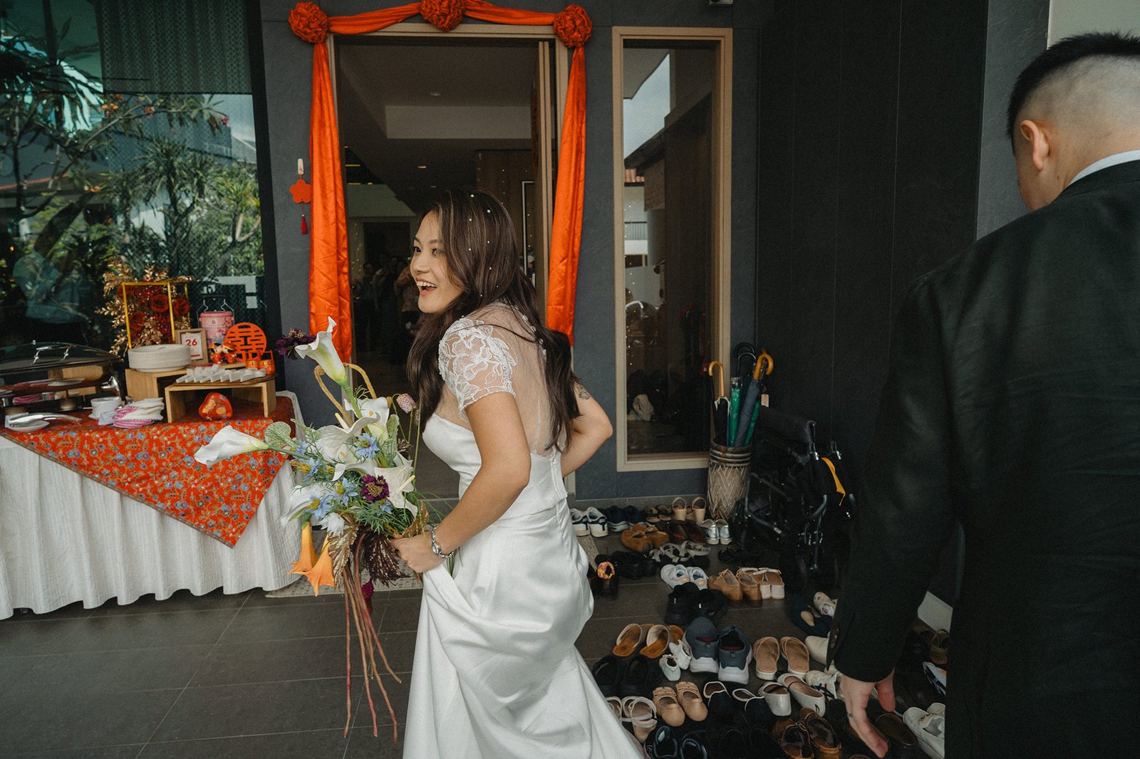 Bride at Atlas Bar Singapore wedding, holding bouquet, smiling.