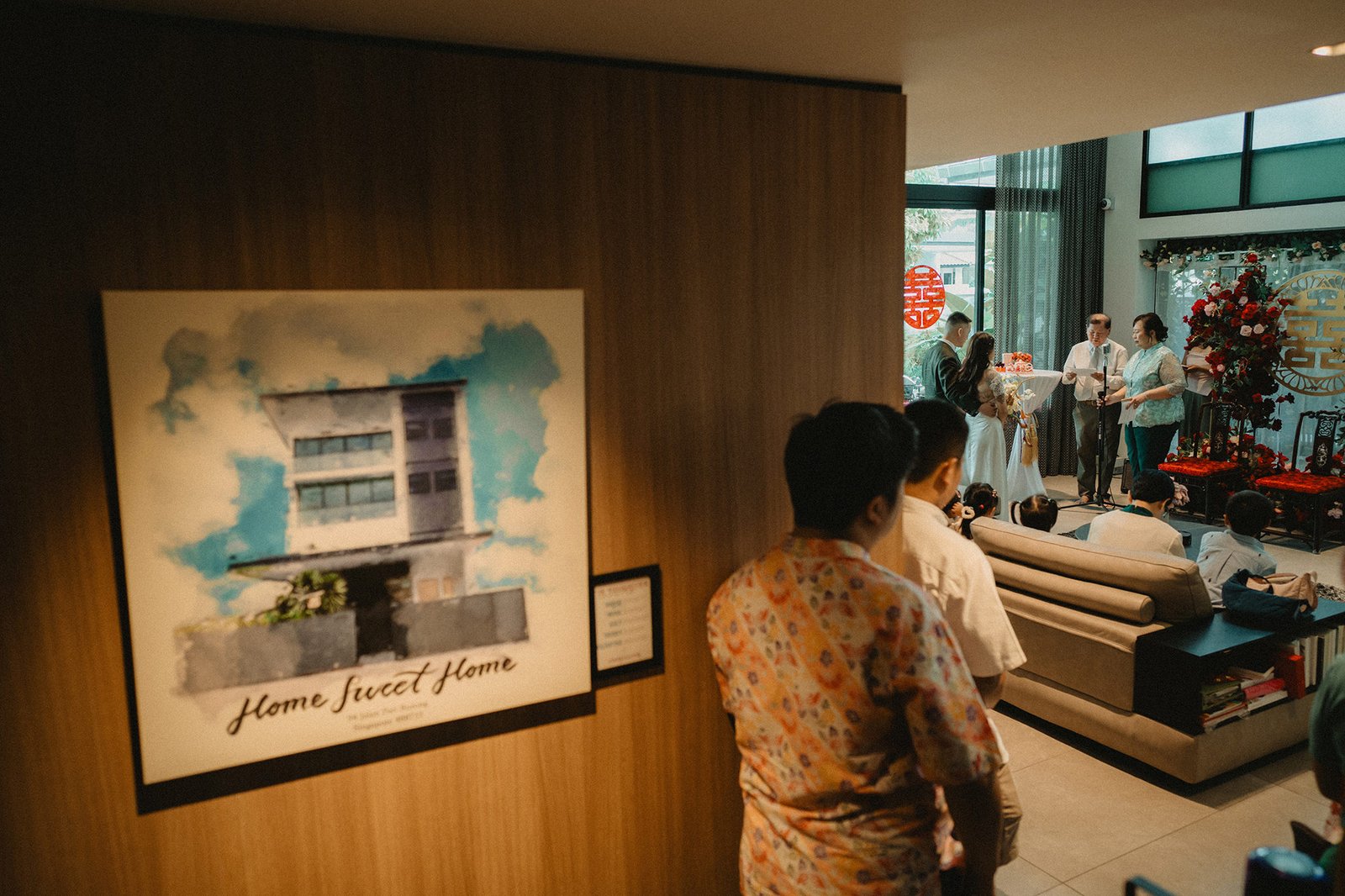 Jared + Xinyu wedding at Atlas Bar Singapore, guests gather near a couch.