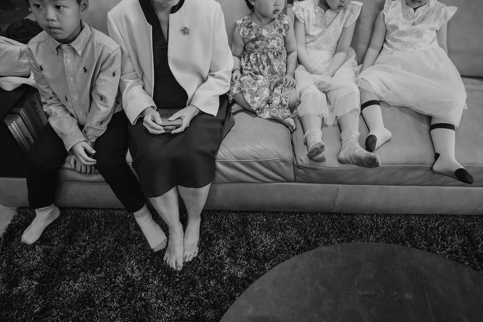 Wedding party at Atlas bar Singapore: Children and adult sit on a couch.