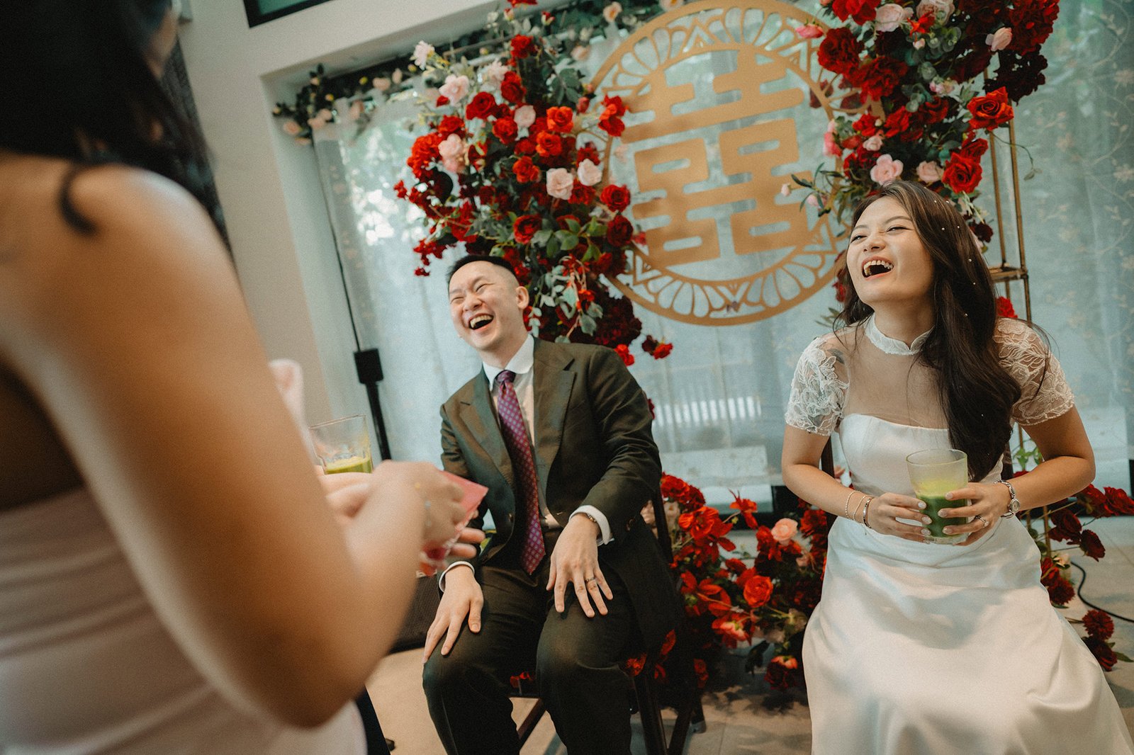 Jared and Xinyu wedding at Atlas Bar Singapore, laughing with guests.