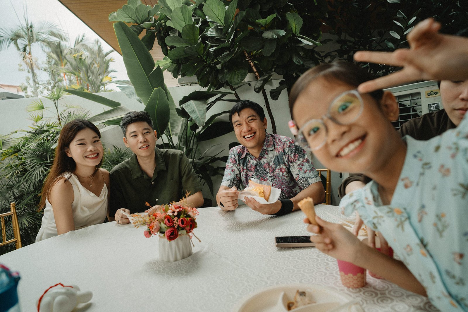 Jared and Xinyu's wedding guests enjoying cake at Atlas bar, Singapore.