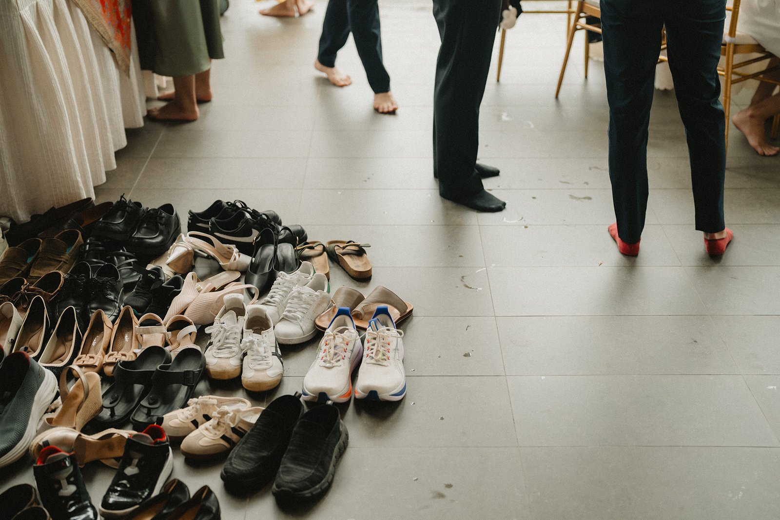 Wedding guests' shoes piled on the floor at Atlas Bar Singapore