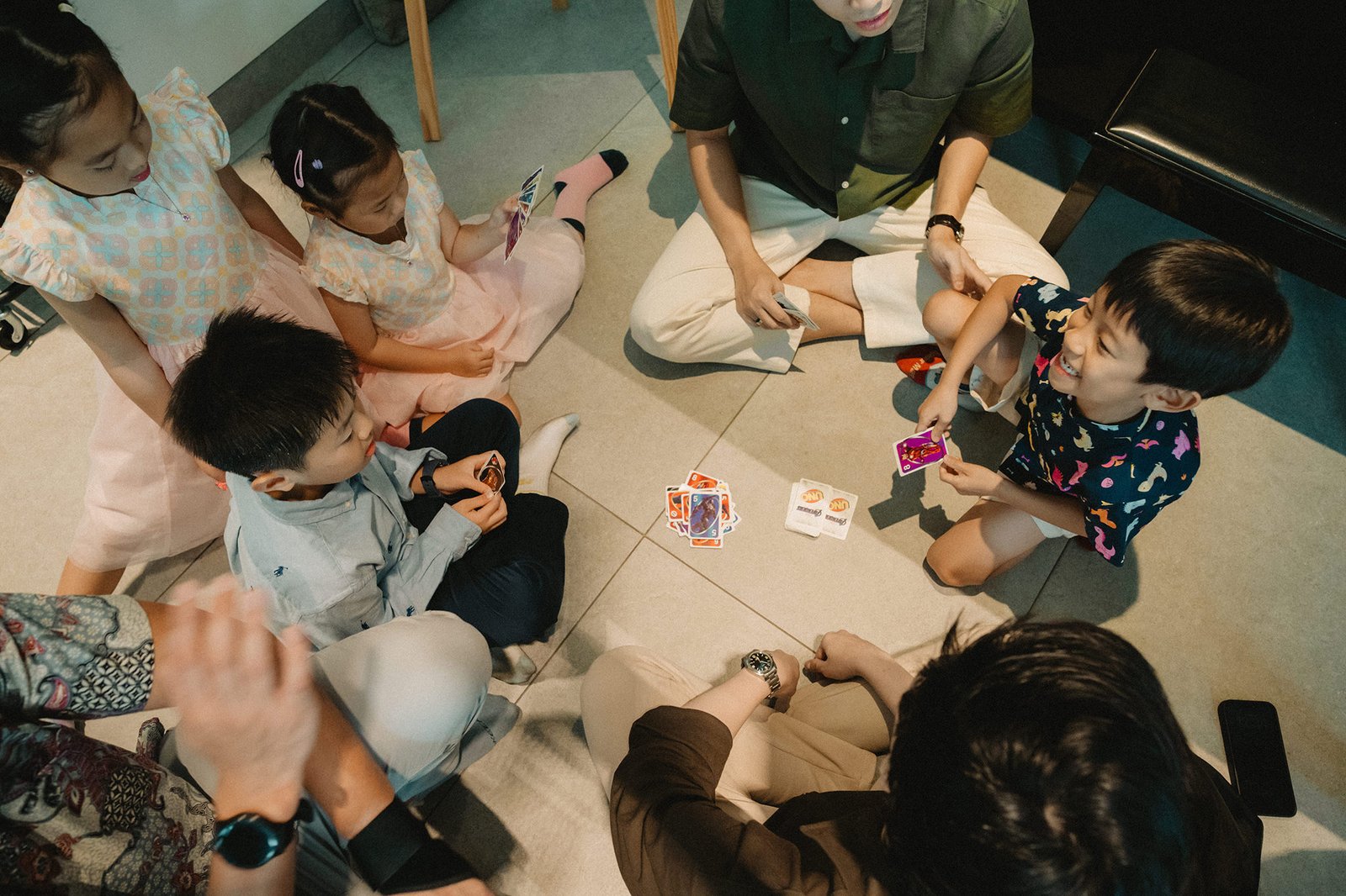 Family playing cards at Atlas bar Singapore wedding reception