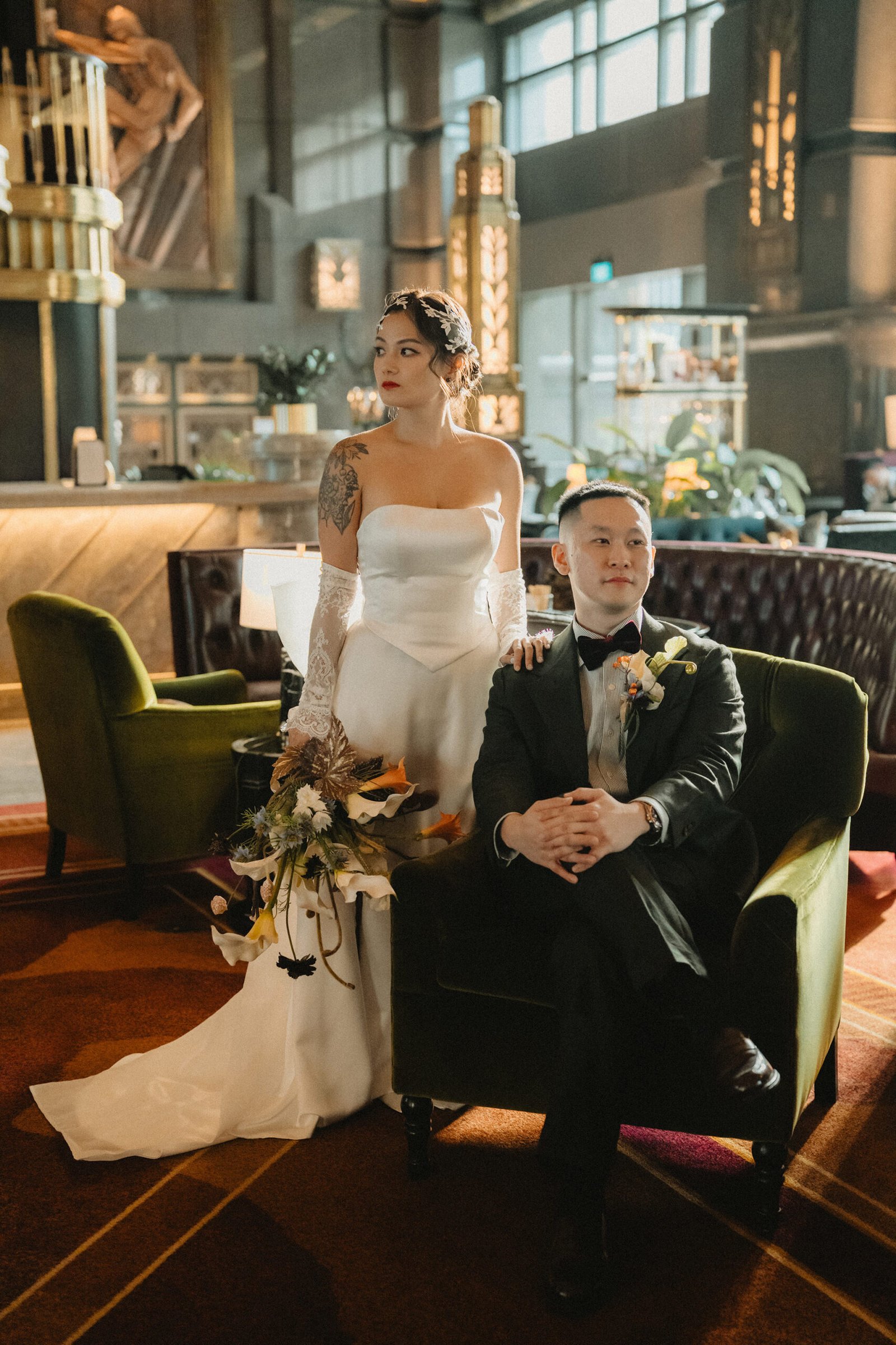 Jared and Xinyu's Atlas Bar Singapore wedding: Bride and groom posing in elegant attire