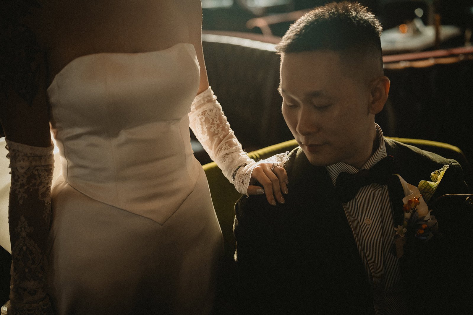 Bride's hand on groom's shoulder at Atlas bar Singapore wedding