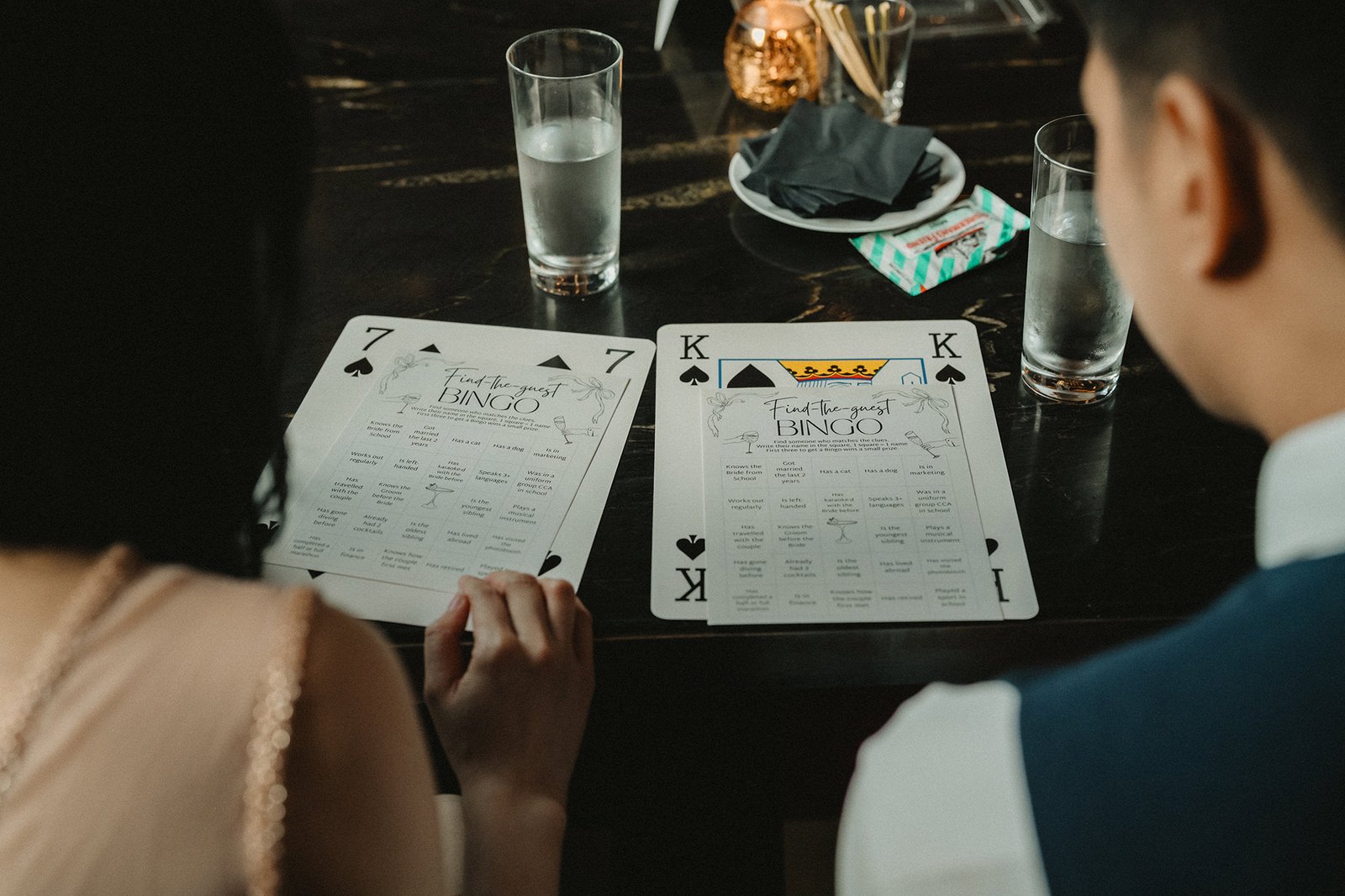 Jared + Xinyu wedding guests play Find-the-Guest Bingo at Atlas Bar Singapore.