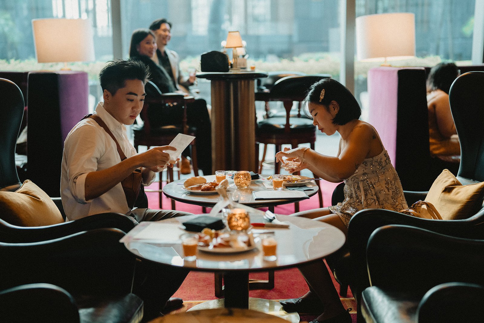 Jared and Xinyu at Atlas Bar Singapore wedding, enjoying drinks and snacks.