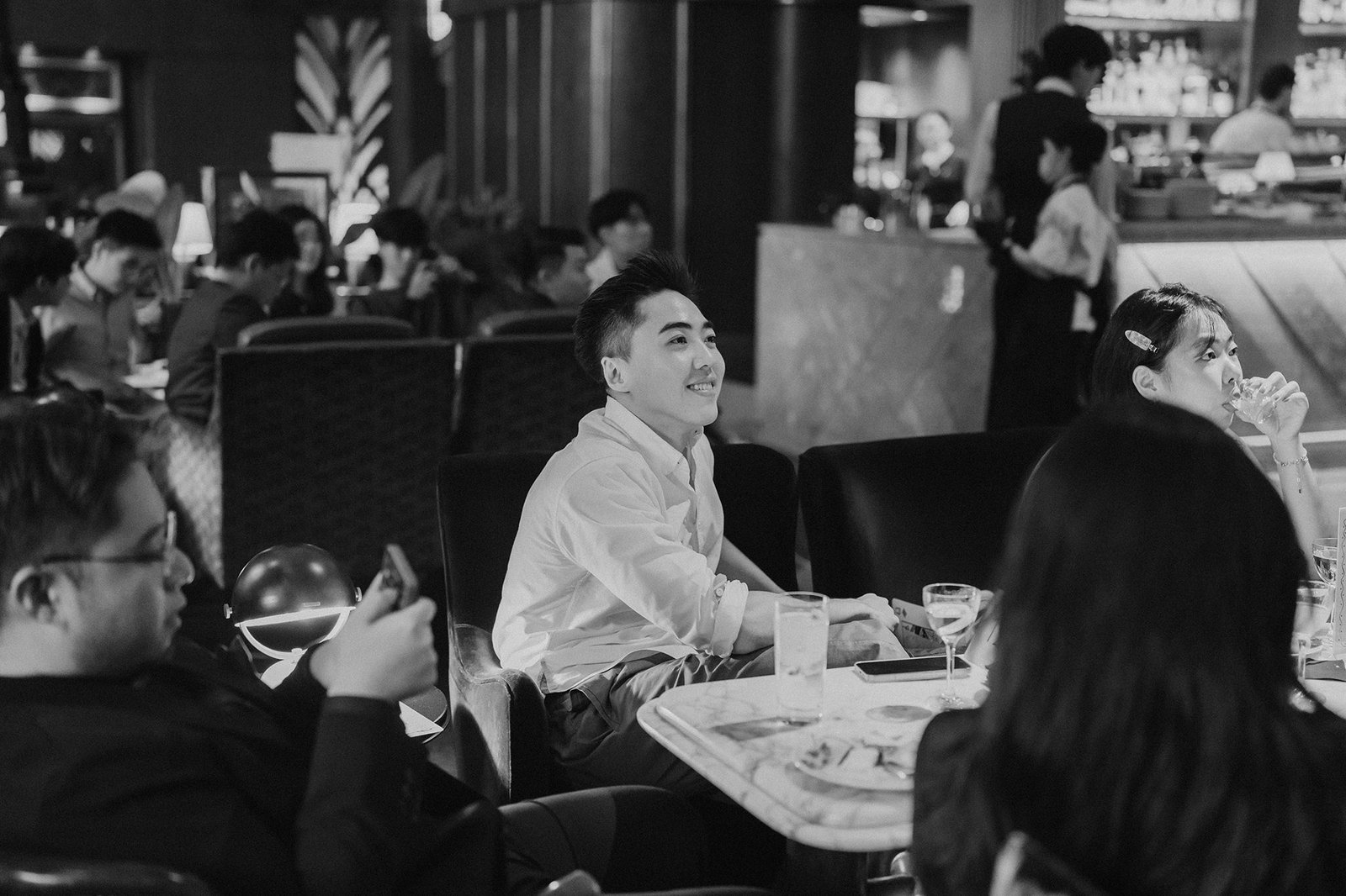 Jared and Xinyu's wedding at Atlas Bar Singapore: guests enjoying the celebration.