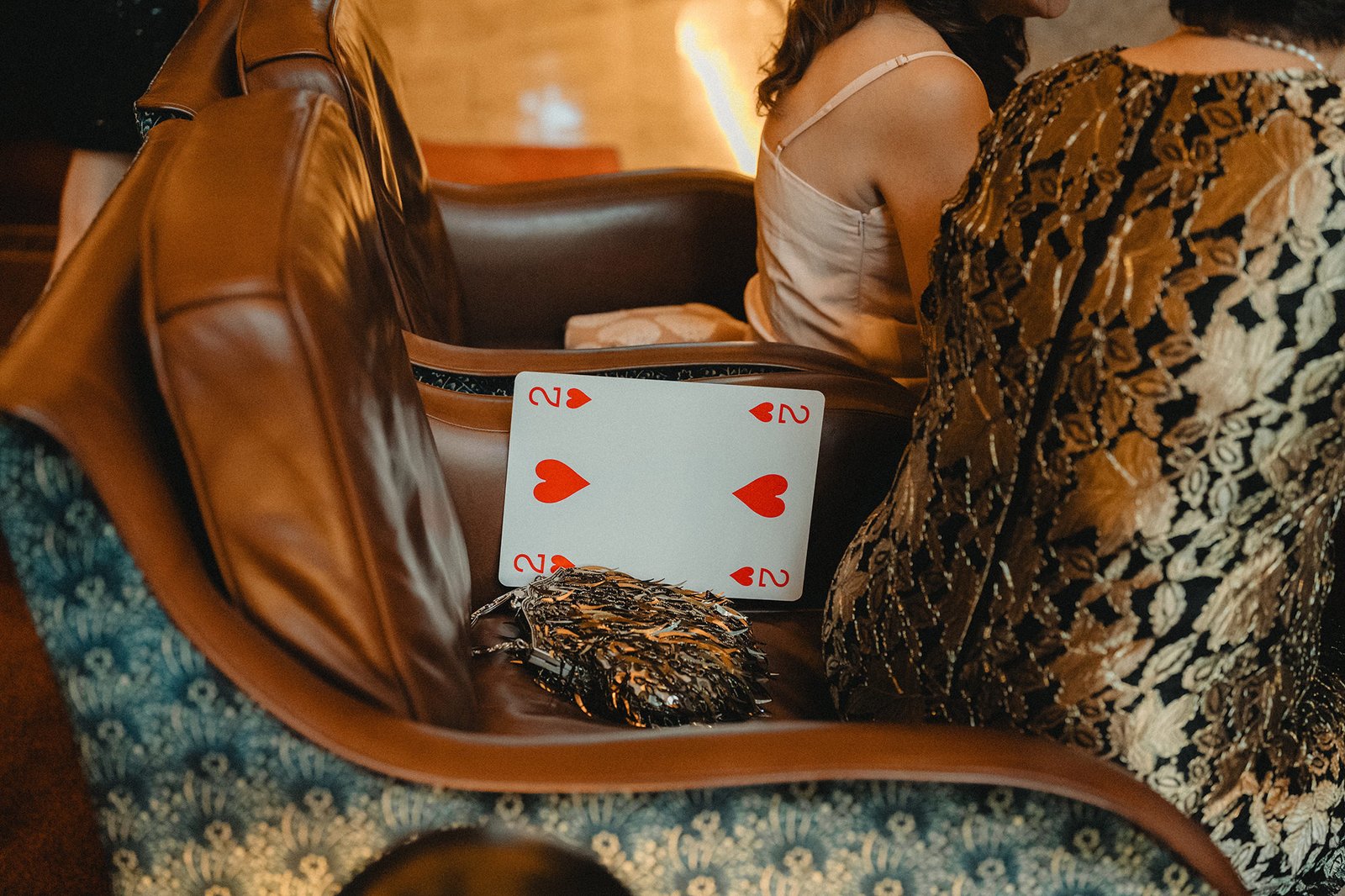 Two of Hearts card and clutch on ornate chair at Atlas Bar Singapore wedding