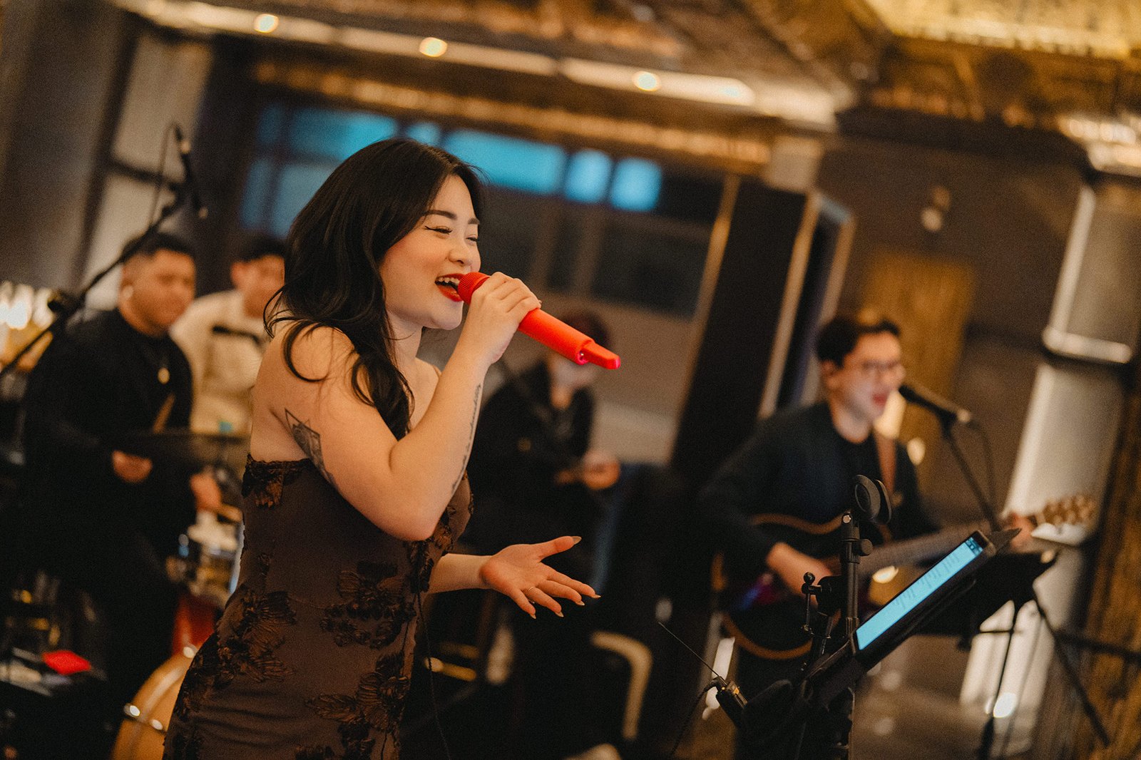 Xinyu singing at Atlas Bar Singapore wedding reception with band