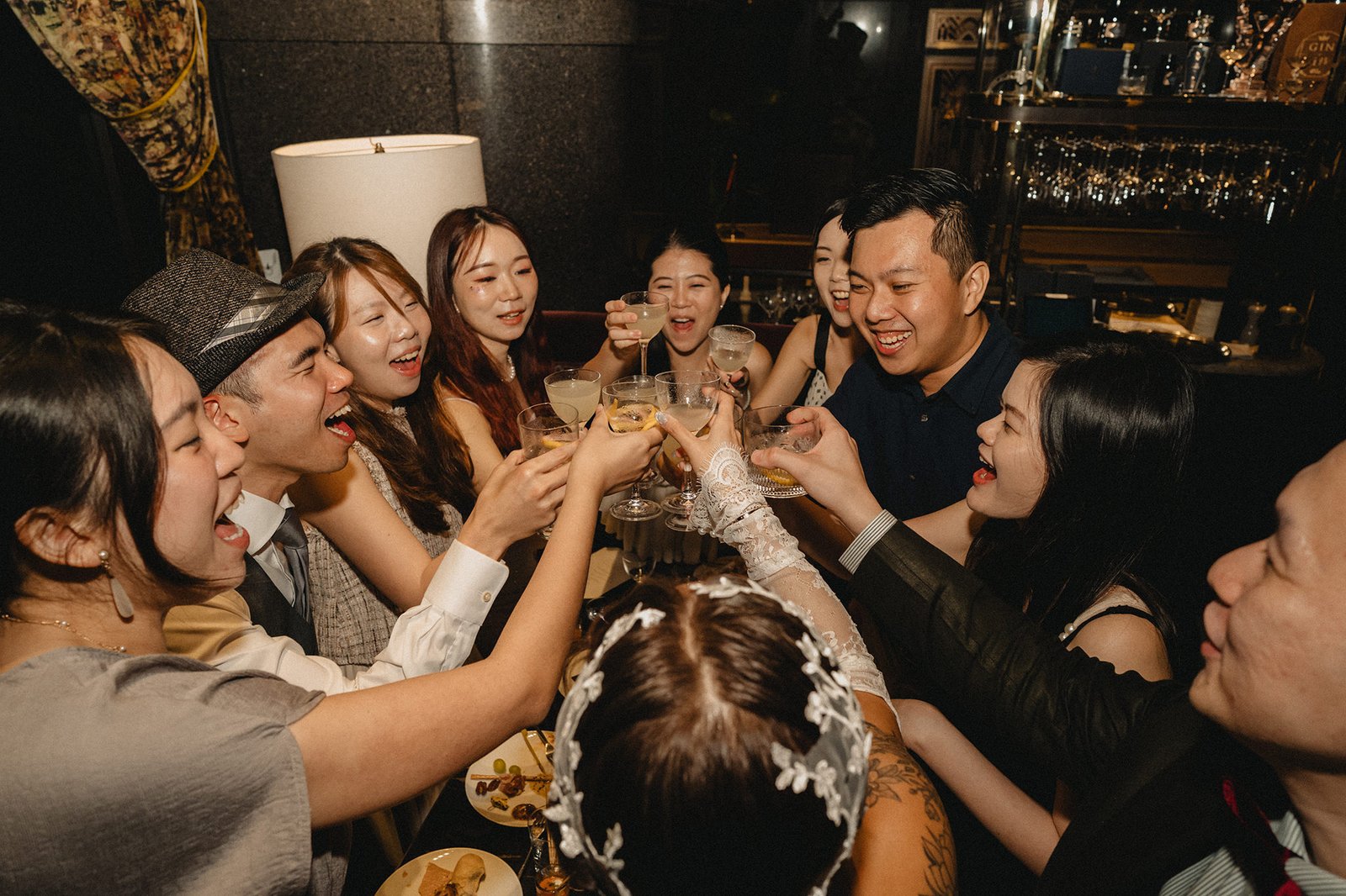 Jared and Xinyu's wedding toast at Atlas Bar Singapore, celebrating with friends.