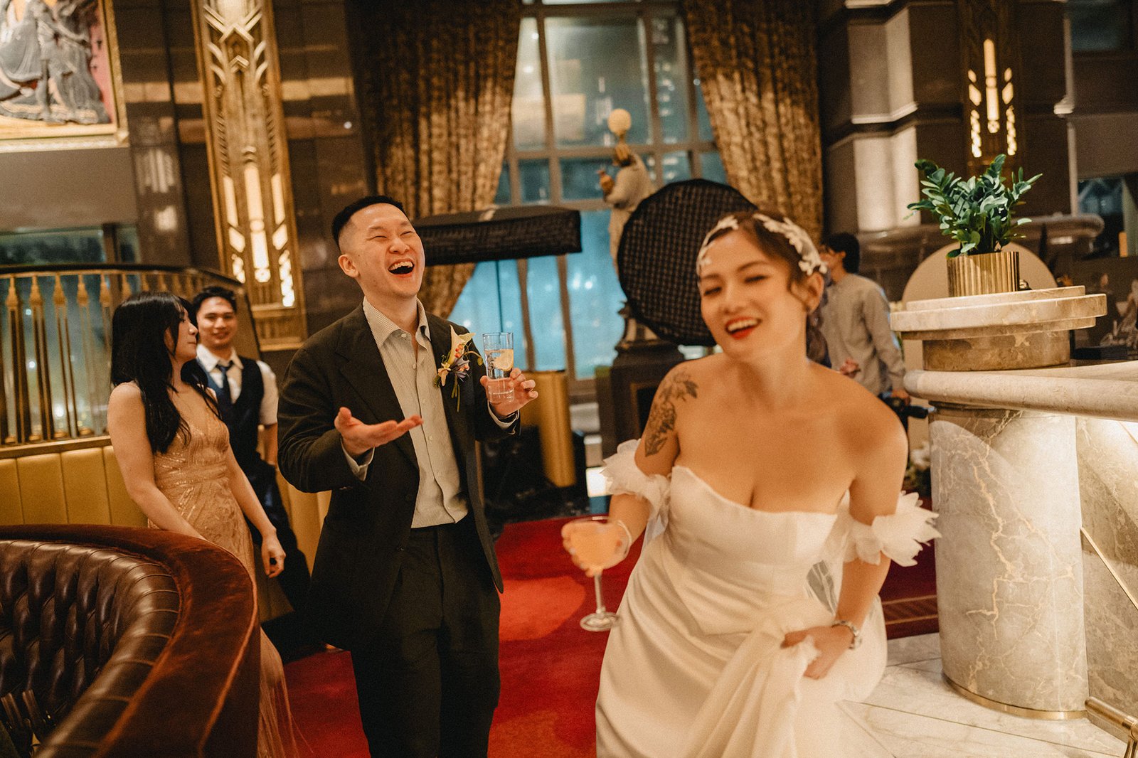 Bride and groom celebrating at Atlas Bar Singapore wedding