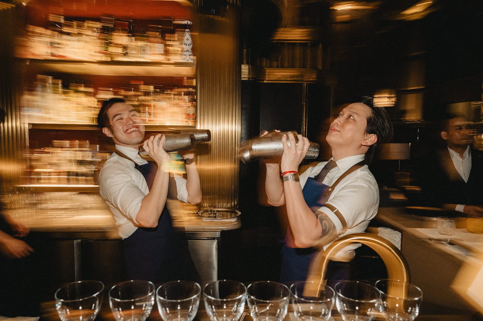 Jared and Xinyu's Atlas Bar Singapore wedding: bartenders shaking cocktails
