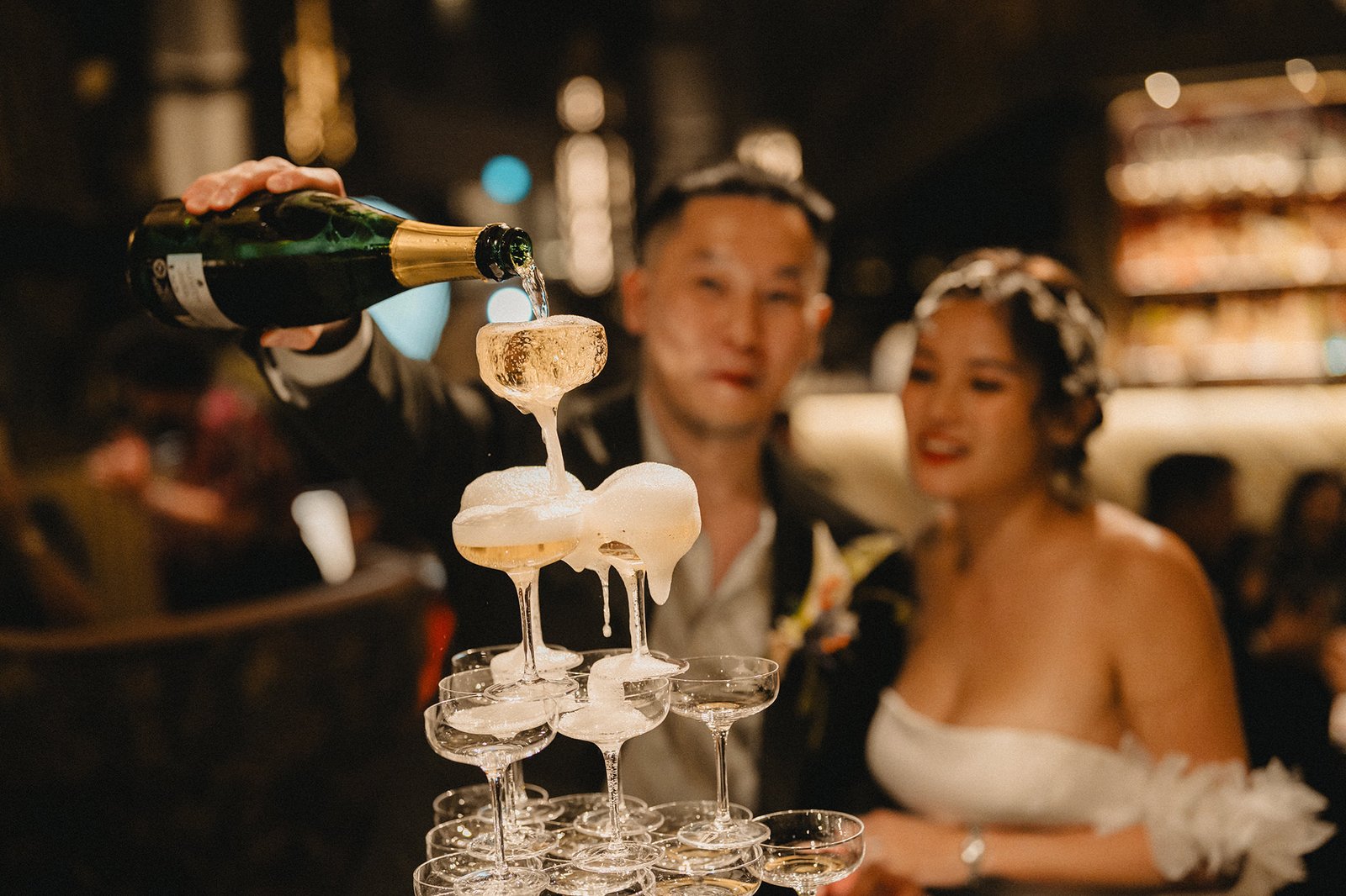 Jared and Xinyu's wedding at Atlas Bar Singapore: Champagne tower pouring.