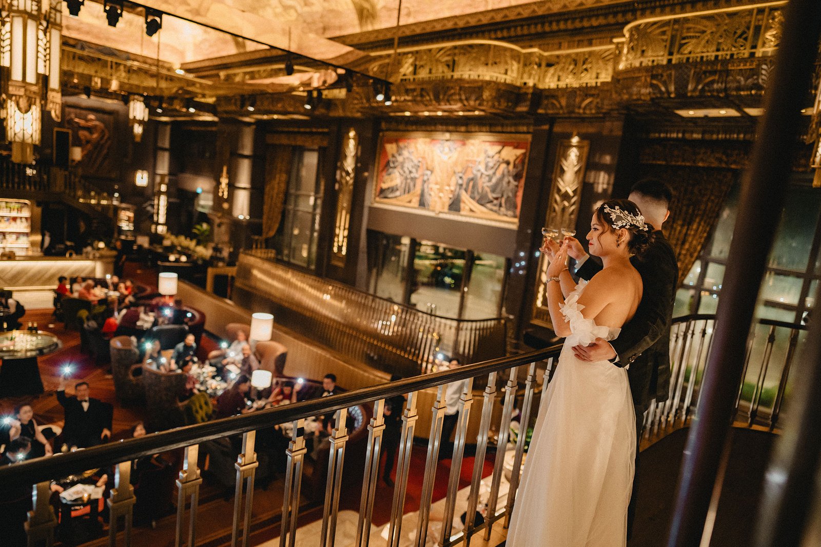 Jared and Xinyu celebrate their Atlas Bar Singapore wedding with champagne.