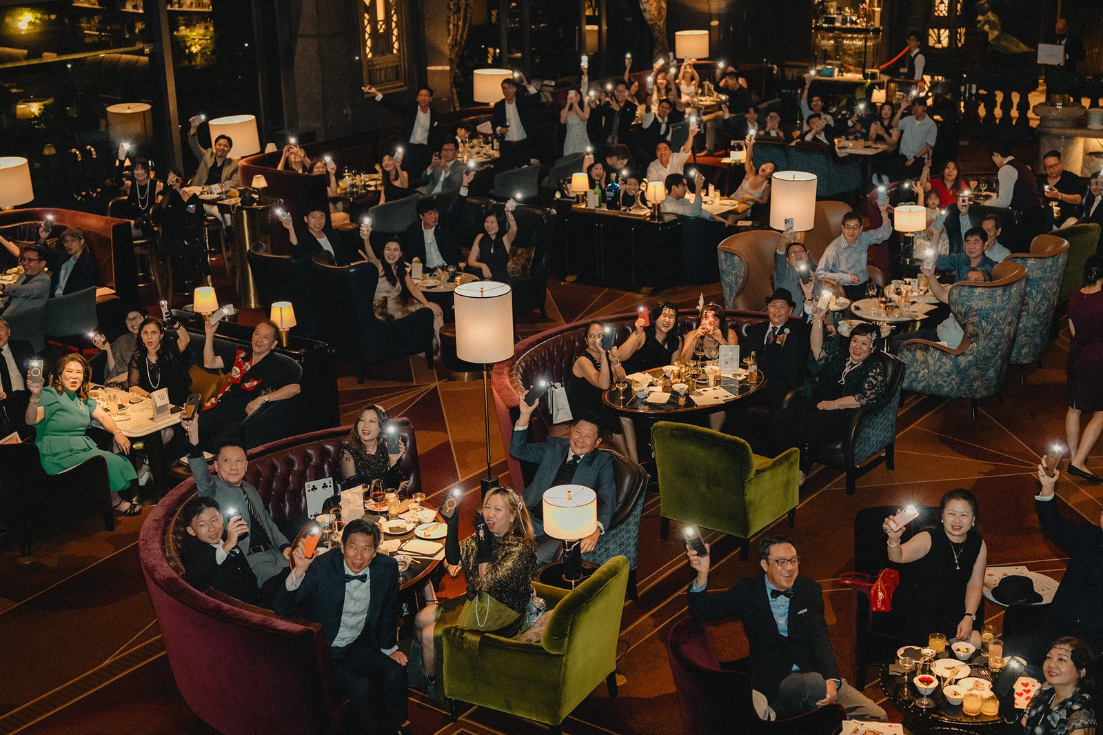 Jared + Xinyu wedding celebration at Atlas Bar Singapore, guests holding up phones