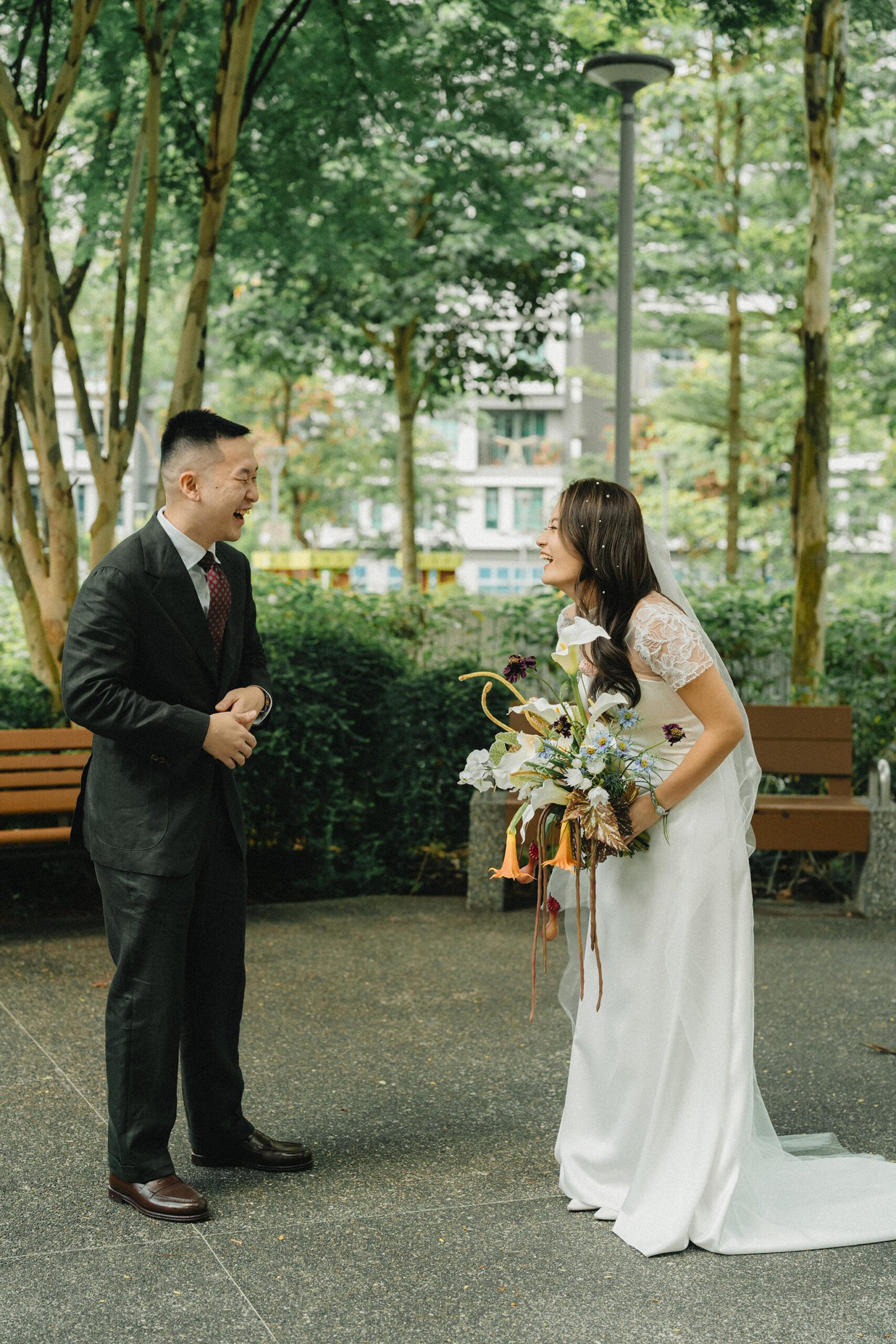 Jared and Xinyu laugh during their Atlas Bar Singapore wedding photoshoot.
