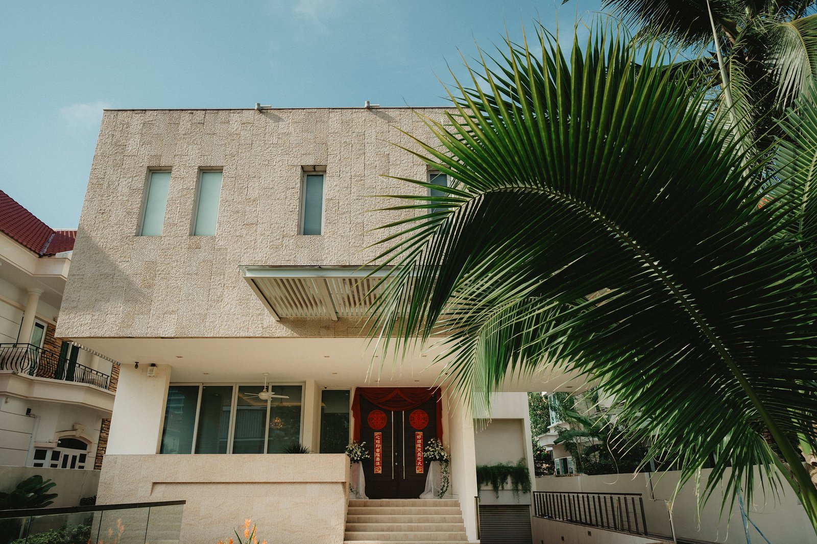 Capella Singapore wedding venue entrance with palm fronds