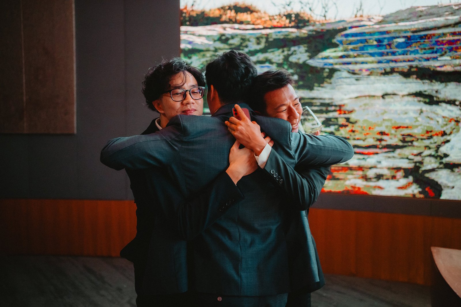 Groomsmen hugging at Capella Singapore wedding