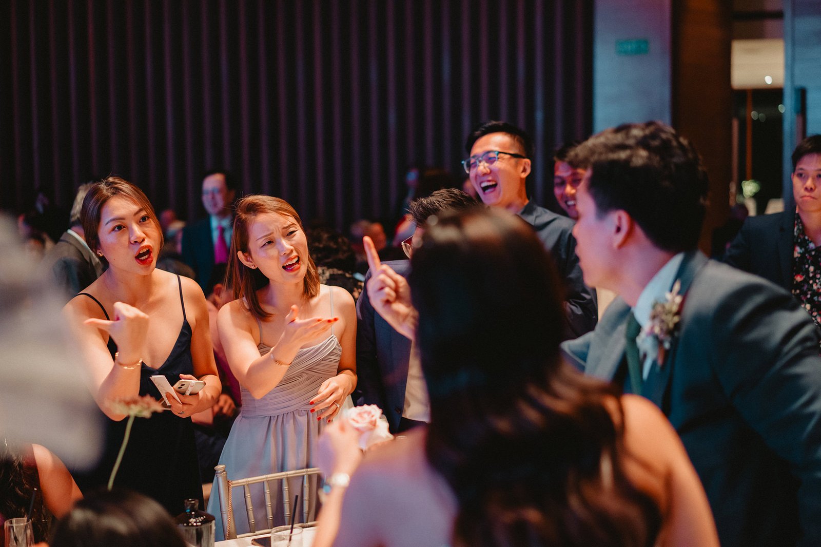 Guests at a Capella Singapore wedding, Han + Ming, share a lively moment.