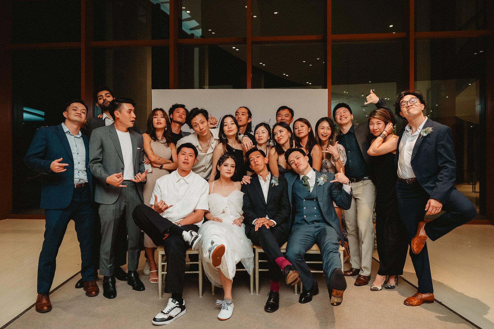 Han + Ming's wedding party at Capella Singapore, a joyful group photo.