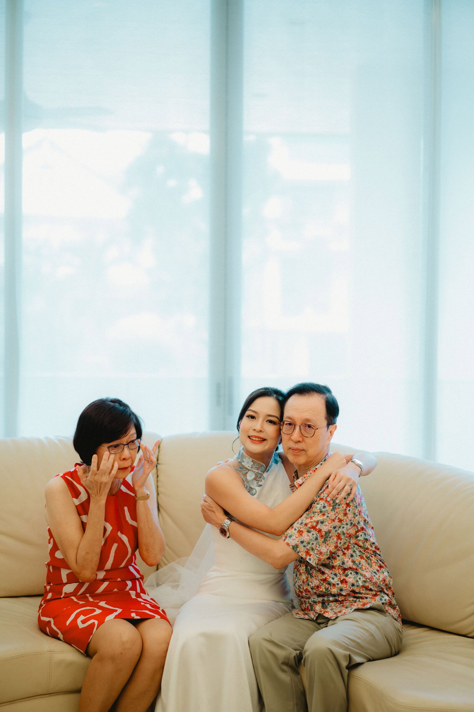 Bride and groom hug at Capella Singapore wedding, mother cries