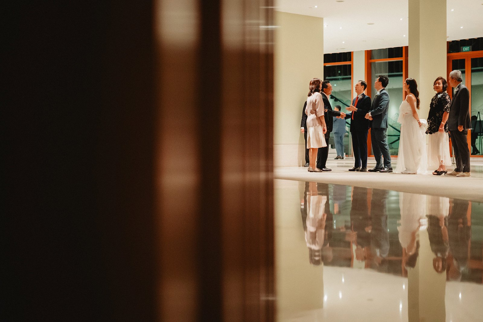 Wedding guests mingle at Capella Singapore, a beautiful wedding venue.