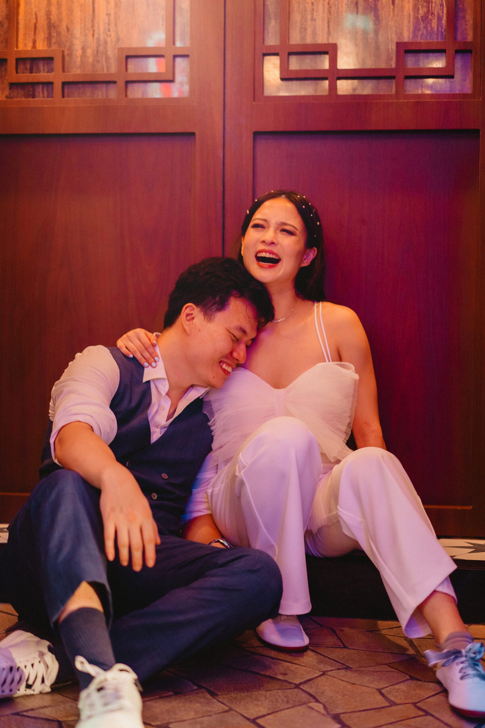Han and Ming laughing at their Capella Singapore wedding.