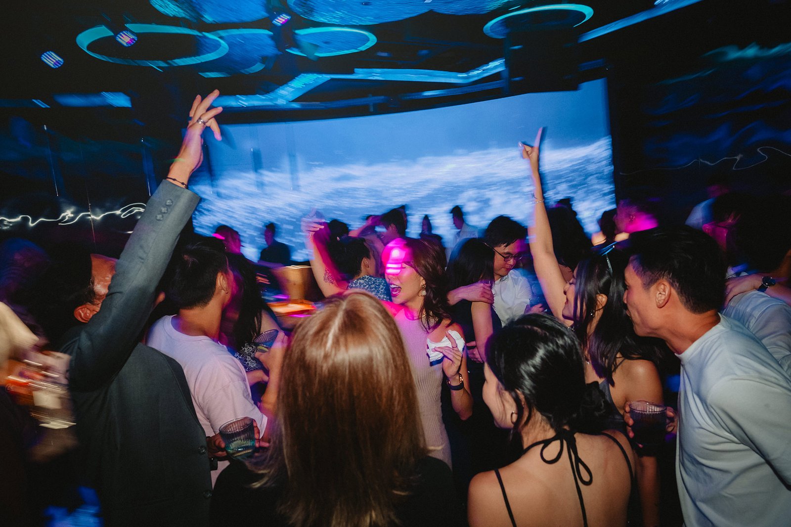 Capella Singapore wedding reception: guests dancing at a lively party