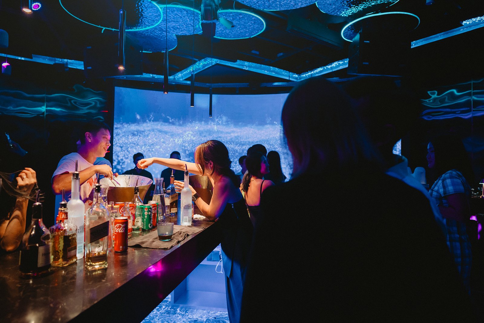 Capella Singapore wedding reception with guests at a vibrant bar