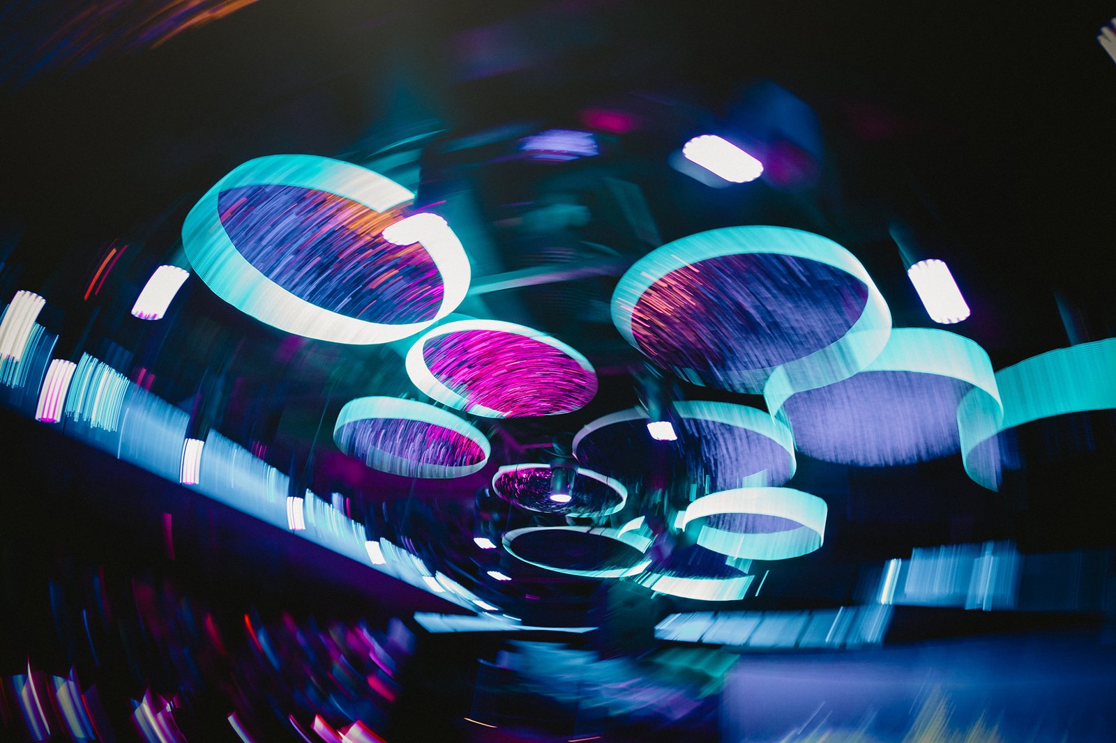 Capella Singapore wedding: Circular light installations glow with teal and magenta hues.