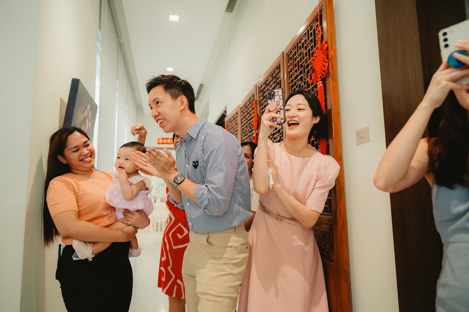 Capella Singapore wedding: Couple with baby and guests celebrating
