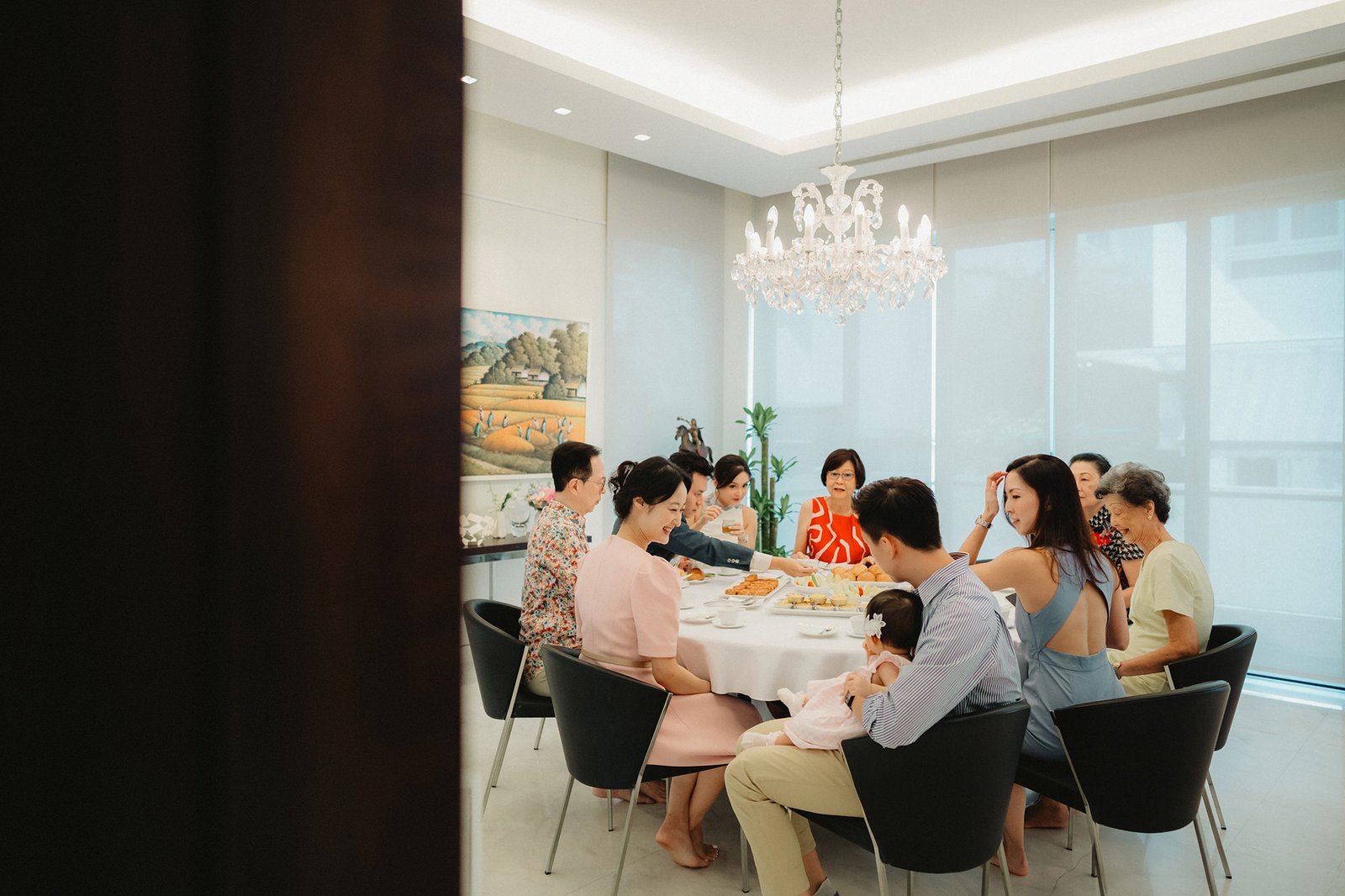 Family gathered around table at Capella Singapore wedding celebration