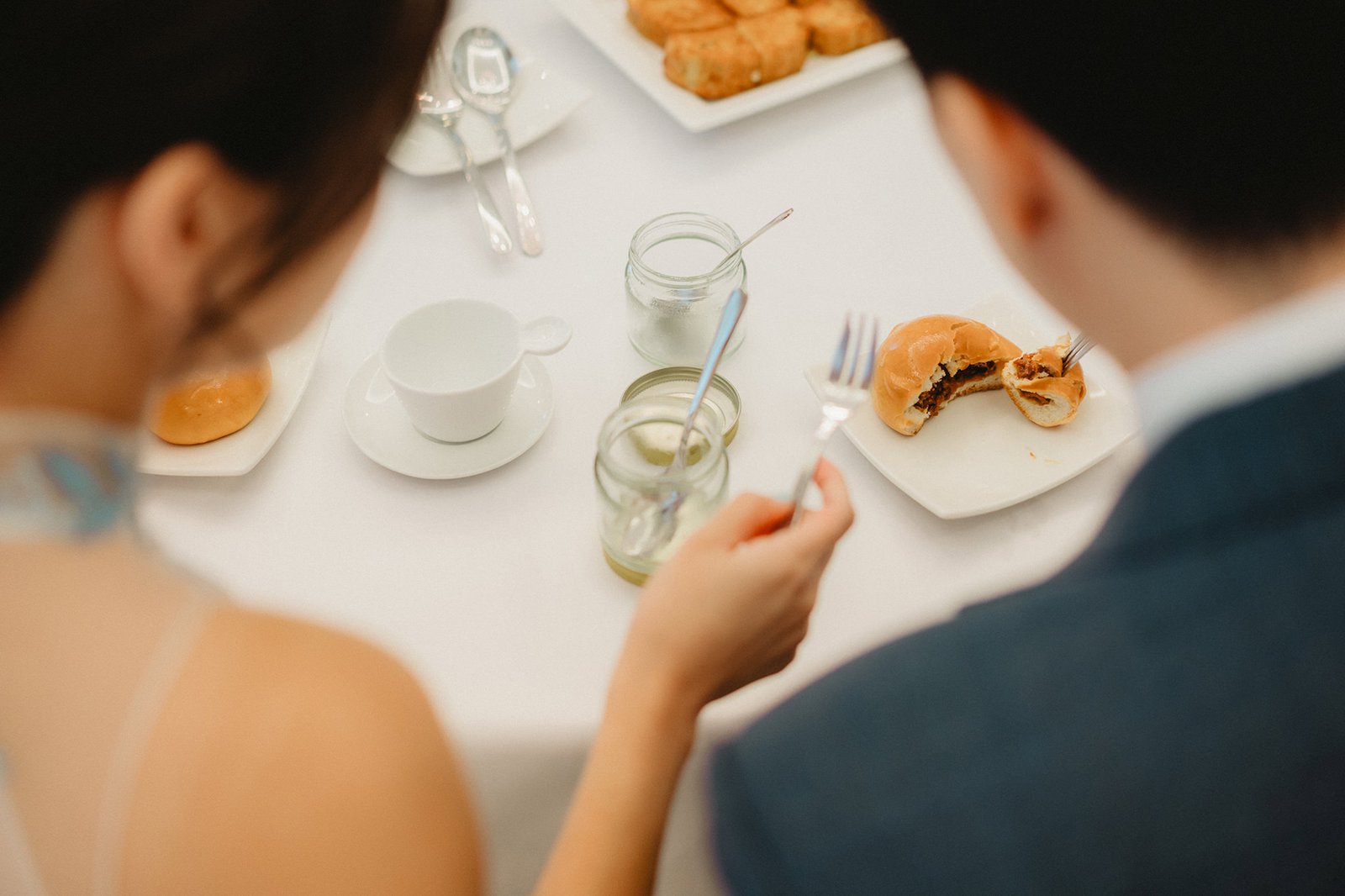 Couple enjoying tea and pastries at Capella Singapore wedding