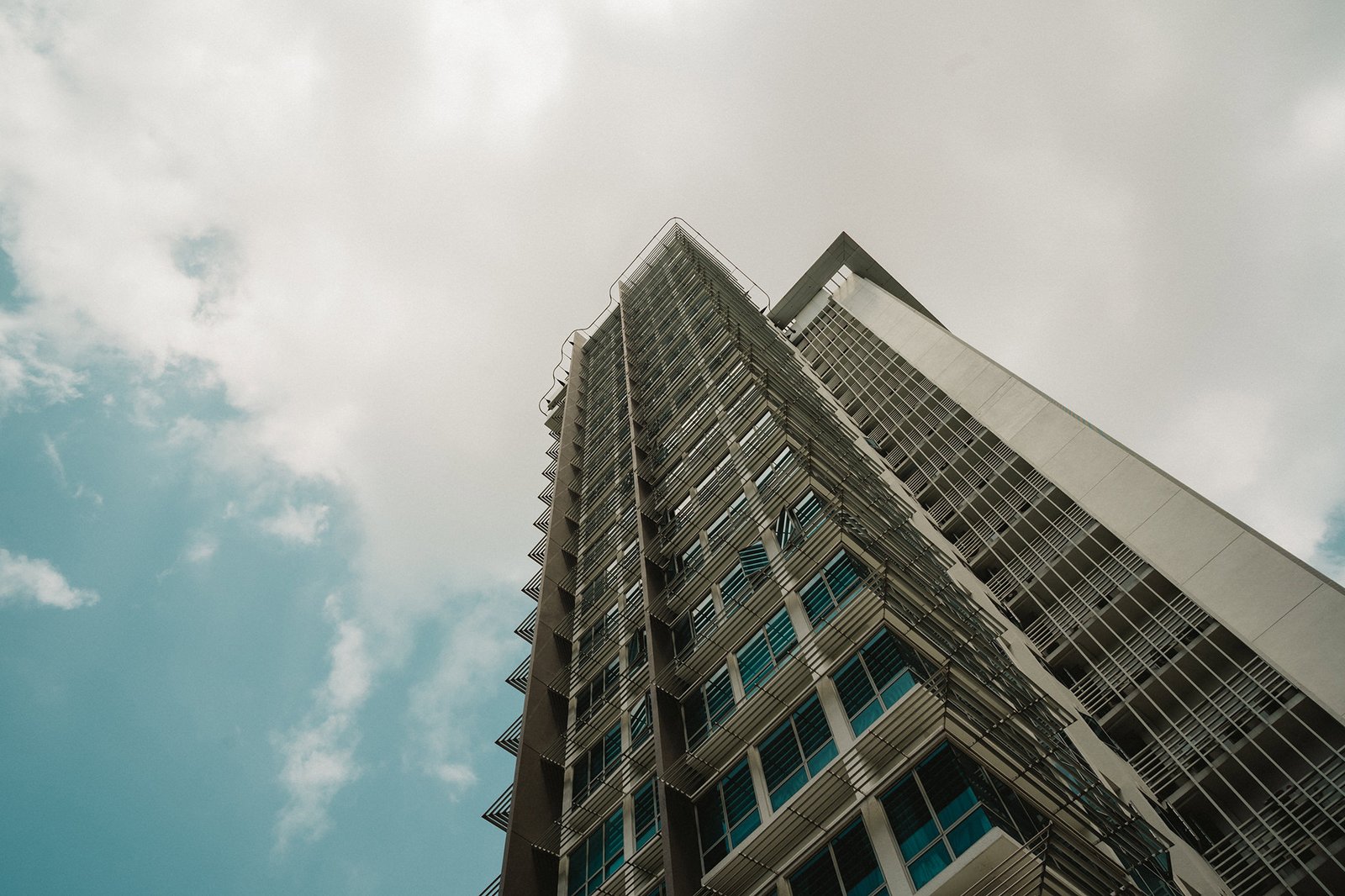 Modern apartment building exterior against a cloudy sky